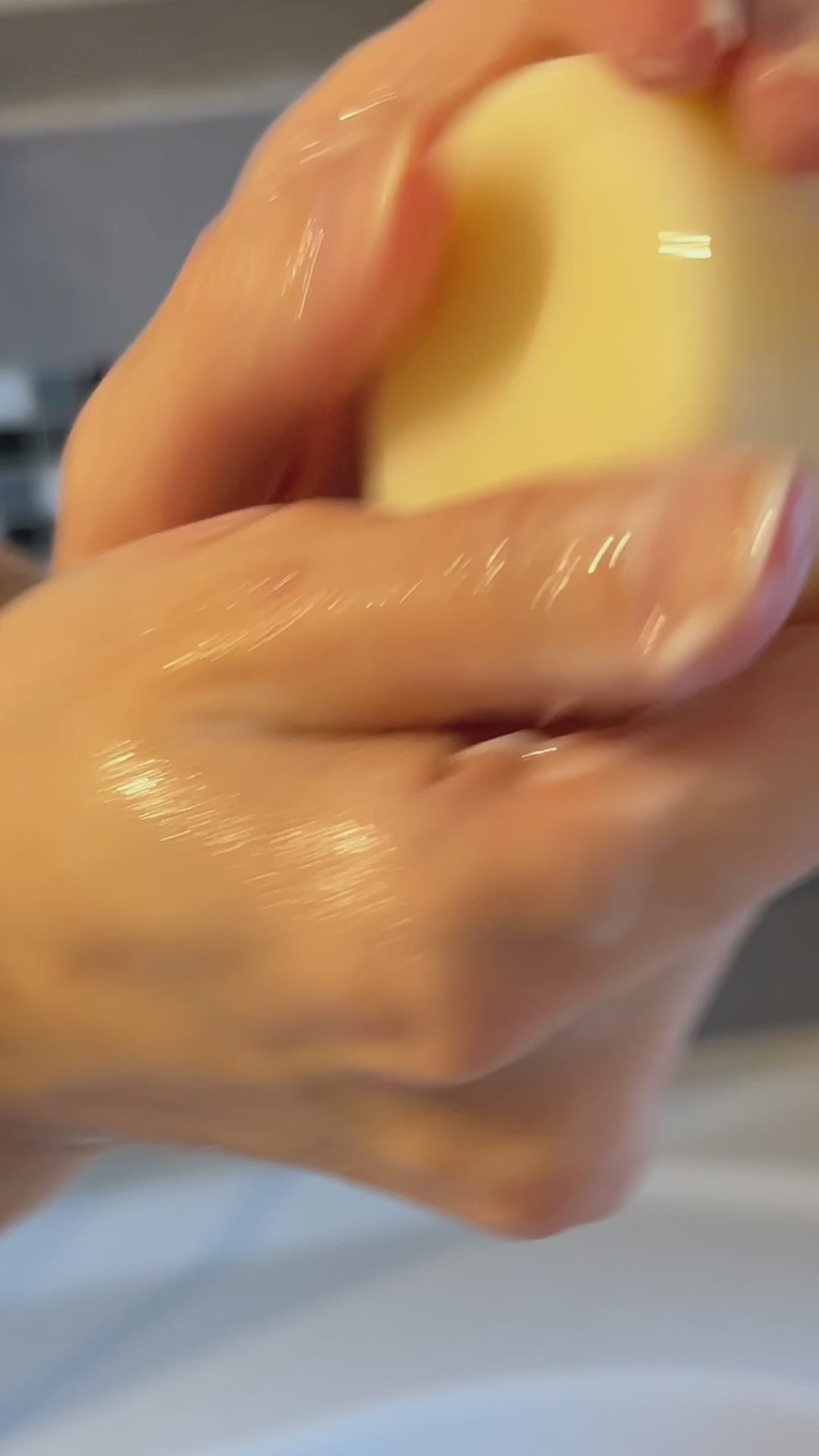 Hands squeezing a solid conditioner bar, showcasing its eco-friendly and organic formulation.